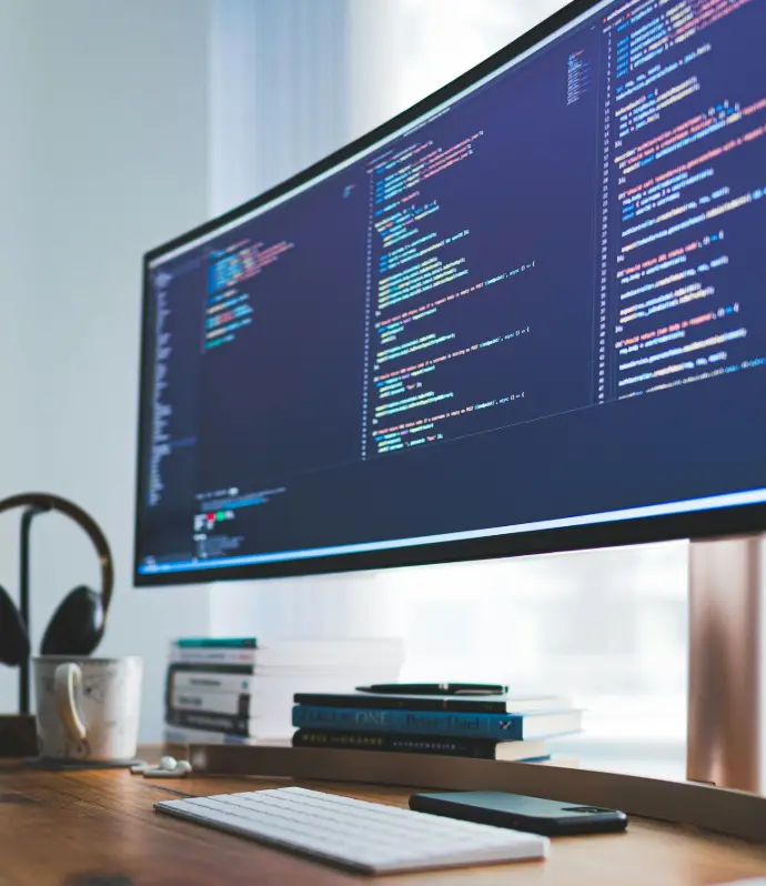 a computer monitor sitting on top of a wooden desk